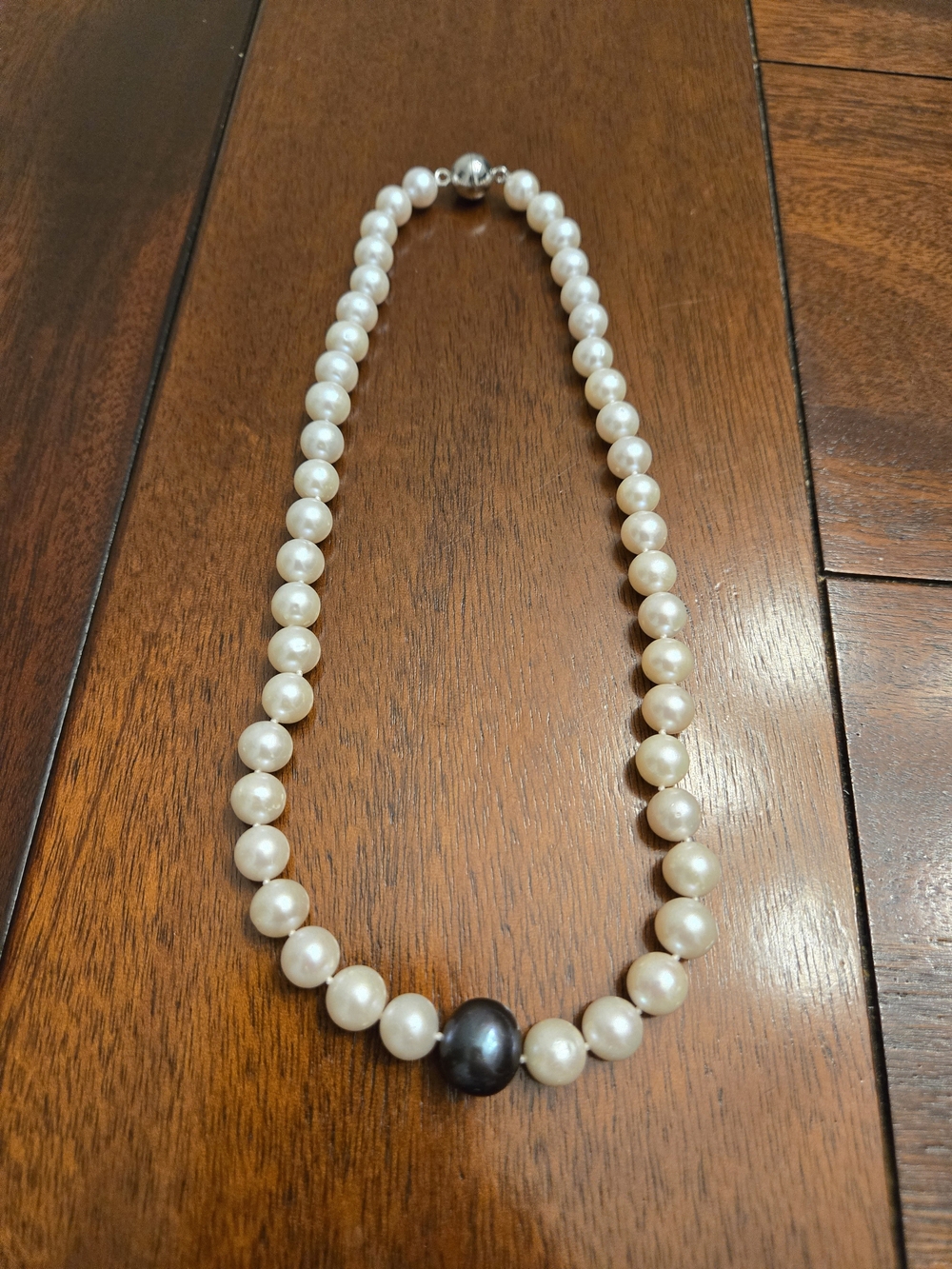Elegant White Pearl Necklace with Single Black Pearl Accent
